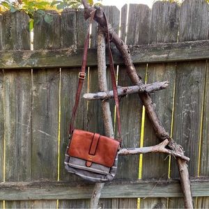Fossil gray and white stripes and leather strap and front flap purse